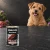 Puszka karmy mokrej John Dog Bażant Pure Black 400 g obok psa