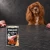 Puszka karmy mokrej John Dog Królik Special Edition 400 g obok psa