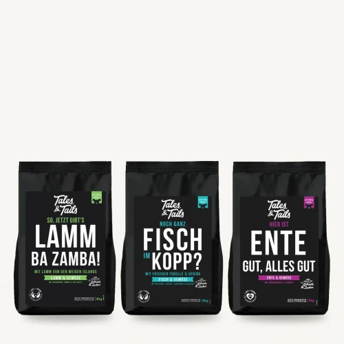 Zestaw karm półwilgotnych Tales & Tails 3 × 4 kg, jagnięcina, ryby, kaczka na jasnym tle.