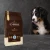 Worek karmy EMPIRE Legendary Taste Puppy Growth Diet 25+ dla szczeniąt dużych ras 12 kg obok szczeniaka berneńskiego psa pasterskiego na ciemnym tle