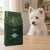 Worek karmy EMPIRE Prime Puppy dla szczeniąt małych i średnich ras 12 kg obok szczeniaka westie w mieszkaniu