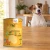 Puszka karmy Syta Micha Indyk z warzywami 400 g obok psa rasy Jack Russell terrier w mieszkaniu